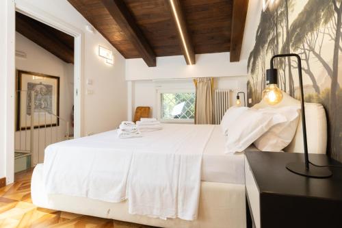 a large white bed in a room with a window at BolognaRoomscom - Isaia Garden Private Garden Spa Bath in Bologna