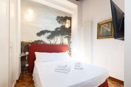 a bedroom with a white bed with a red headboard at BolognaRoomscom - Isaia Garden Private Garden Spa Bath in Bologna