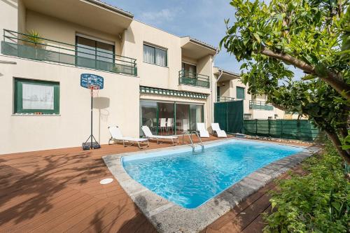a swimming pool in front of a house at Relaxing time near the river in Penafiel