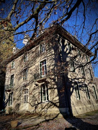 an old stone building with a tree in front of it at Villa Isabelle in Allevard