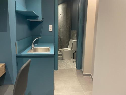 a bathroom with a sink and a toilet at MP luxury houses Ι2 in Larisa