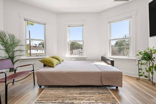 a bedroom with a bed in a room with windows at 10Guests! Parking 2ND FLOOR-Duplex in Fair Lawn