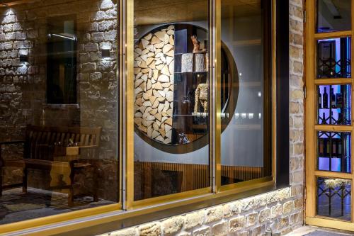 a store window with a round mirror in it at Hotel Beit Maimon in Zikhron Ya‘aqov