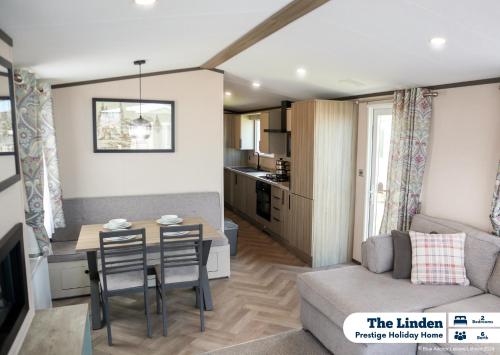 a living room and kitchen with a table and a couch at Golden Palm Resort in Chapel Saint Leonards