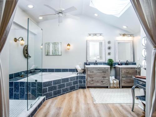 a bathroom with a tub and a glass shower at Palm Suite in Key West