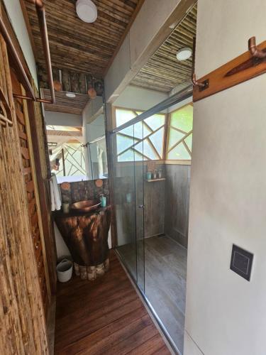 a bathroom with a glass shower and a sink at Burú Nature Hotel in Leticia