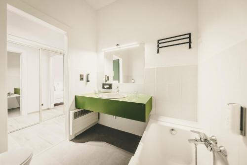 a white bathroom with a sink and a mirror at Fleur De Neige Châtel in Châtel