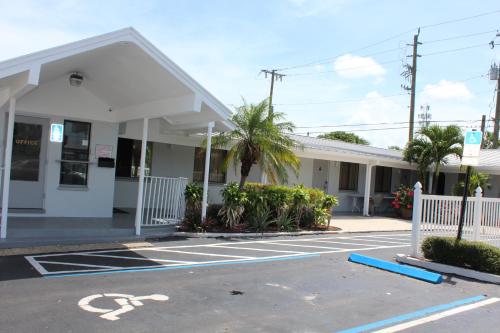 an empty parking lot in front of a building at Economy Inn in West Palm Beach
