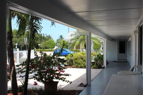 an open porch with a view of a garden at Economy Inn in West Palm Beach