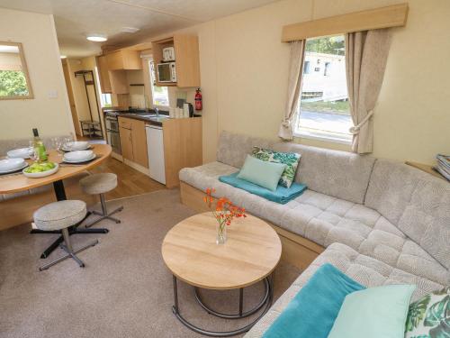 a living room with a couch and a table at Greenwood in Cowes