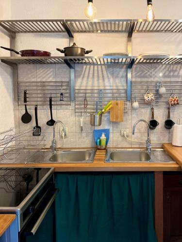 a kitchen with two sinks and utensils on the wall at HealthyStudio512 Apartments in Kotor