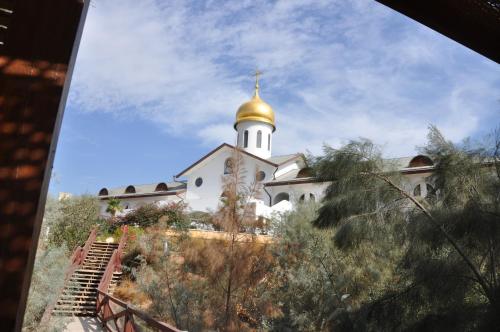 a church with a gold dome on top of it at Russian Pilgrim Residence in Sowayma