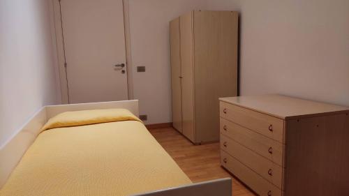 a small bedroom with a bed and a dresser at A casa di Sara in Recanati