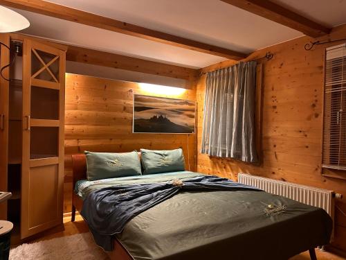 a bedroom with a bed in a wooden room at Weil ich es mir wert bin in Seehausen am Staffelsee