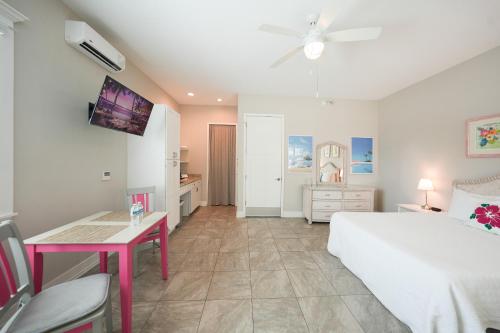 a bedroom with a bed and a table and a desk at Sunny Side Cottages in Dunedin