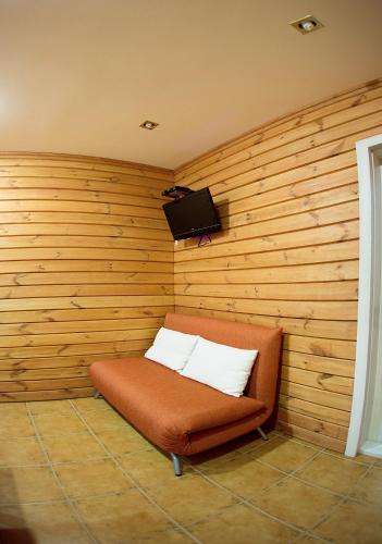 a bench in a room with a wooden wall at ABC Apartments Business Class in Kyiv