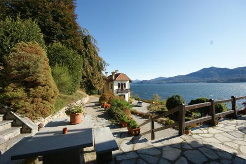 a house on a hill next to a body of water at Miralba in Ghiffa