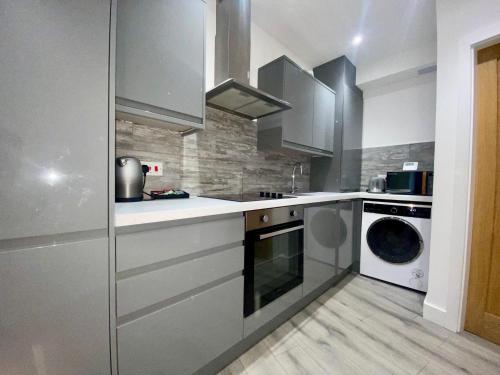 a kitchen with a washing machine and a washer at Apartment 4 in Manchester