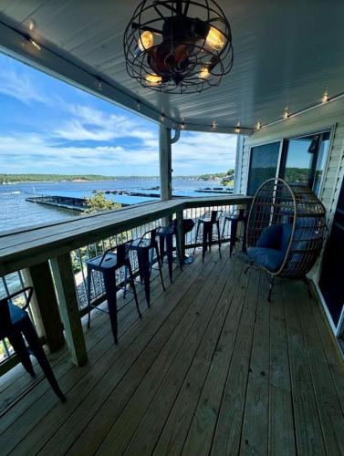 a porch with chairs and a chandelier on a boat at Lake Ozark's Lakefront Oasis with Fireplace, Game Room, Theater & More! in Osage Beach