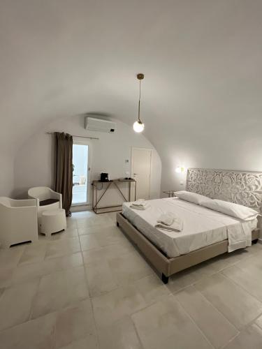 a bedroom with a bed and a table and a chair at Donna Vita in Monopoli
