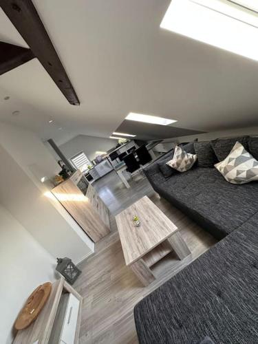 a living room with a couch and a table at Panoramablick in Litzendorf in Litzendorf