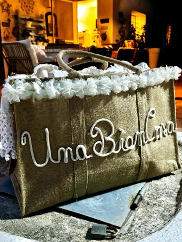 a gold bag with the name mimosa bling on it at Una Biancasa in Carovigno