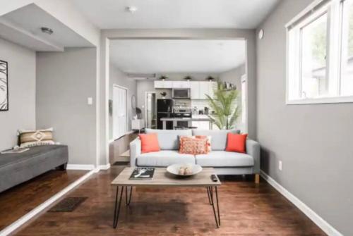 a living room with a couch and a table at Cozy 1BR Getaway - BBQ - Backyard - Pet - Friendly in Indianapolis