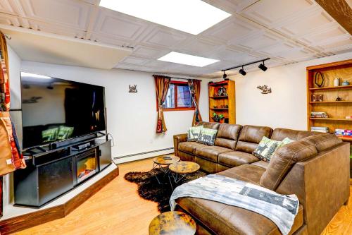 a living room with a couch and a flat screen tv at Ideally Located Fairbanks Vacation Rental! in Fairbanks