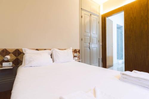 Ένα ή περισσότερα κρεβάτια σε δωμάτιο στο ORM - Bolhao Apartments