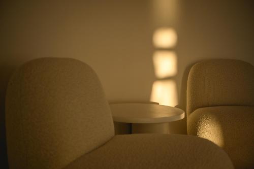 two chairs and a table in a room at Yperia Hotel in Aegiali