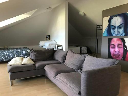 a living room with a couch and a staircase at Villa Volcan in Le Tampon