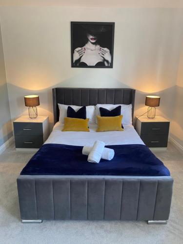 a bedroom with a large bed with two night stands at The Heathers - Spacious 3 Bed, Home from Home in Burton in Burton upon Trent
