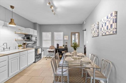 a kitchen with a glass table and chairs in it at Sleep 5 - Pet & Baby - Laundry - Closer to Hospitals in Indianapolis