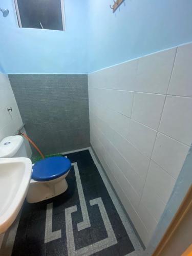 a bathroom with a toilet and a sink at Ilham Restu Homestay Private Pool MSLIM ONLY in Port Dickson