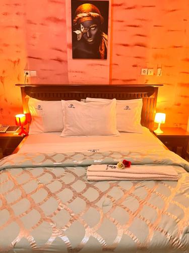 a bedroom with a large bed with at Prodiges Hôtel in Yaoundé