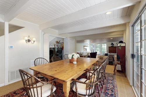 a dining room with a wooden table and chairs at The Great Escape in Arnold