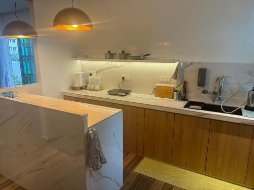 a kitchen with a sink and a counter top at Jambul Villa 3-storey corner House 6Bed5Bathroom in Bayan Lepas