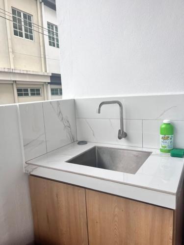 a kitchen counter with a sink and a window at Jambul Villa 3-storey corner House 6Bed5Bathroom in Bayan Lepas