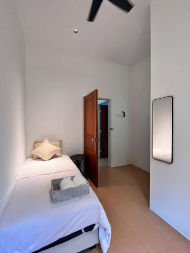 a white bedroom with a bed and a mirror at Jambul Villa 3-storey corner House 6Bed5Bathroom in Bayan Lepas