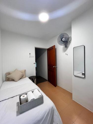 a bedroom with a bed with two towels on it at Jambul Villa 3-storey corner House 6Bed5Bathroom in Bayan Lepas