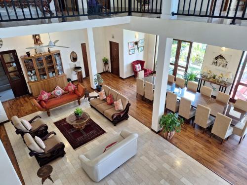 an aerial view of a living room and dining room at MYH - Lake Front Pvt Villa with Staff and Includes FREE Breakfast of your choice in Bandaragama