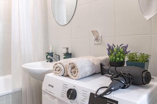 a washer and dryer sitting on a counter in a bathroom at Apartment near EXPO-2017, Hilton in Taldykolʼ