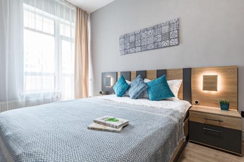 a bedroom with a large bed with a tray on it at Apartment near EXPO-2017, Hilton in Taldykolʼ