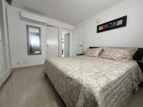 a bedroom with a bed and a mirror on the wall at El Rodadero, 4 habitaciones con piscina y terraza in Gaira