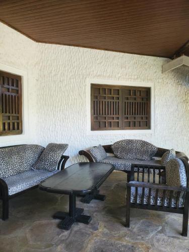 a room with couches and a table and a wall at Villa Ceera,2 Bedroom in Kijiwetanga
