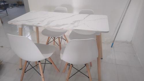 a white marble table and chairs in a room at Homestay Afeeya kuala krai in Kuala Kerai