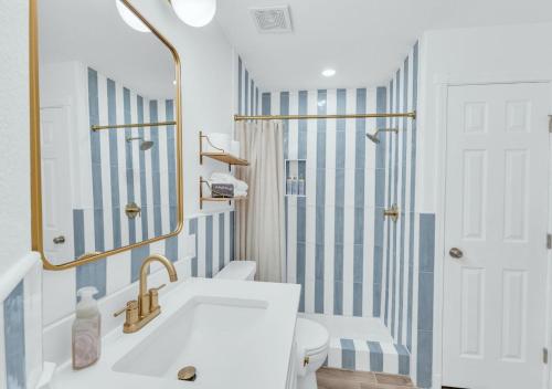 a bathroom with a sink and a shower at Poolside Paradise in Galveston