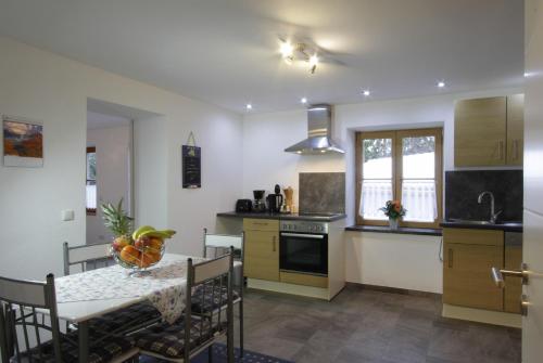 a kitchen with a table and a dining room at Haus Ingrid in Trauchgau