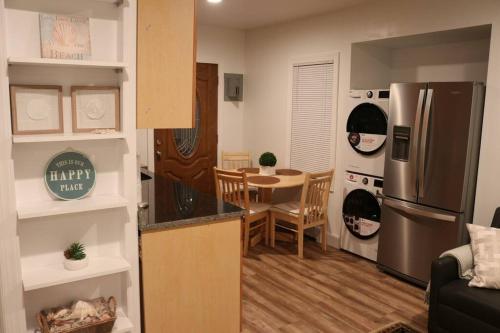 a kitchen with a stainless steel refrigerator and a table at Villetta del Mar in Belmar