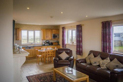 a living room with a couch and a table at Atlantic Sunset in Aughrus More